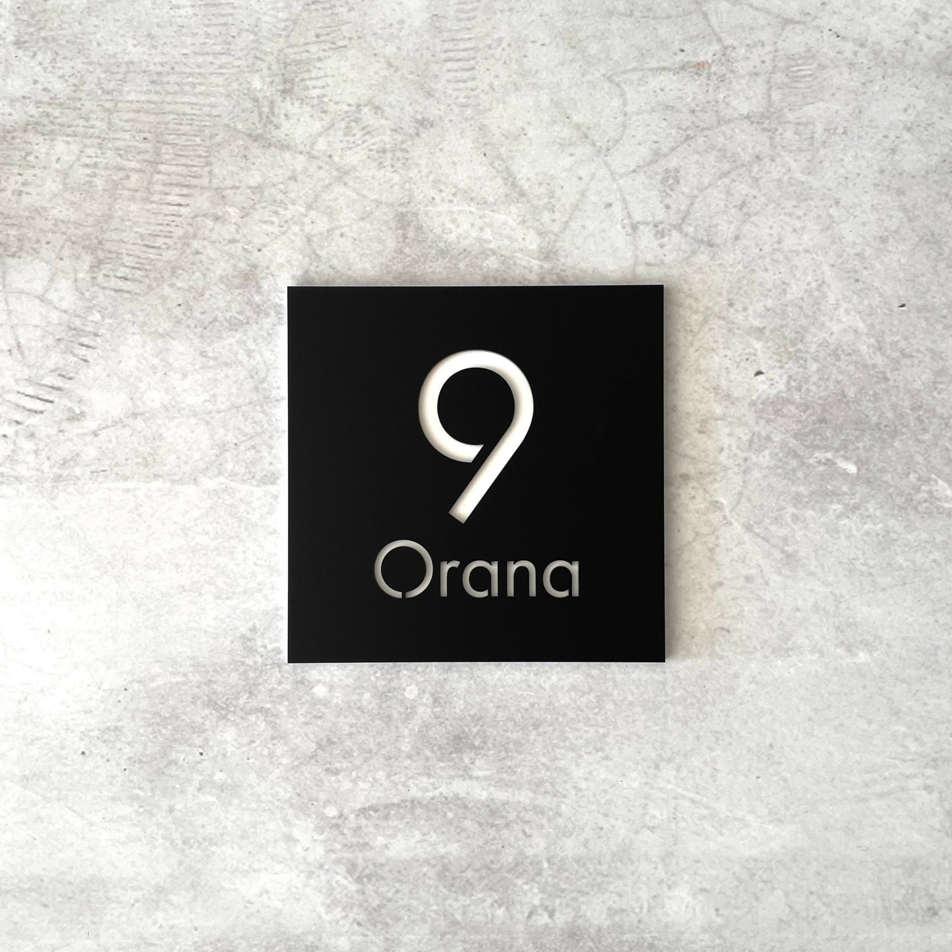 Modern square house number sign which includes street name