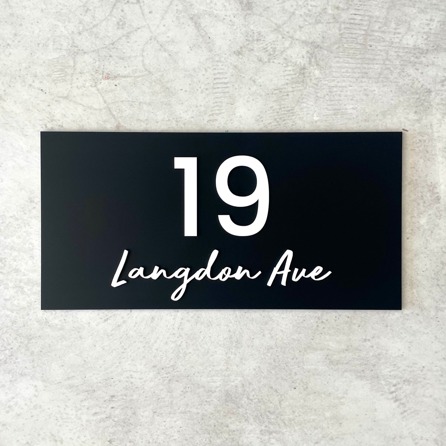 Unique house number featuring street name in a modern script font
