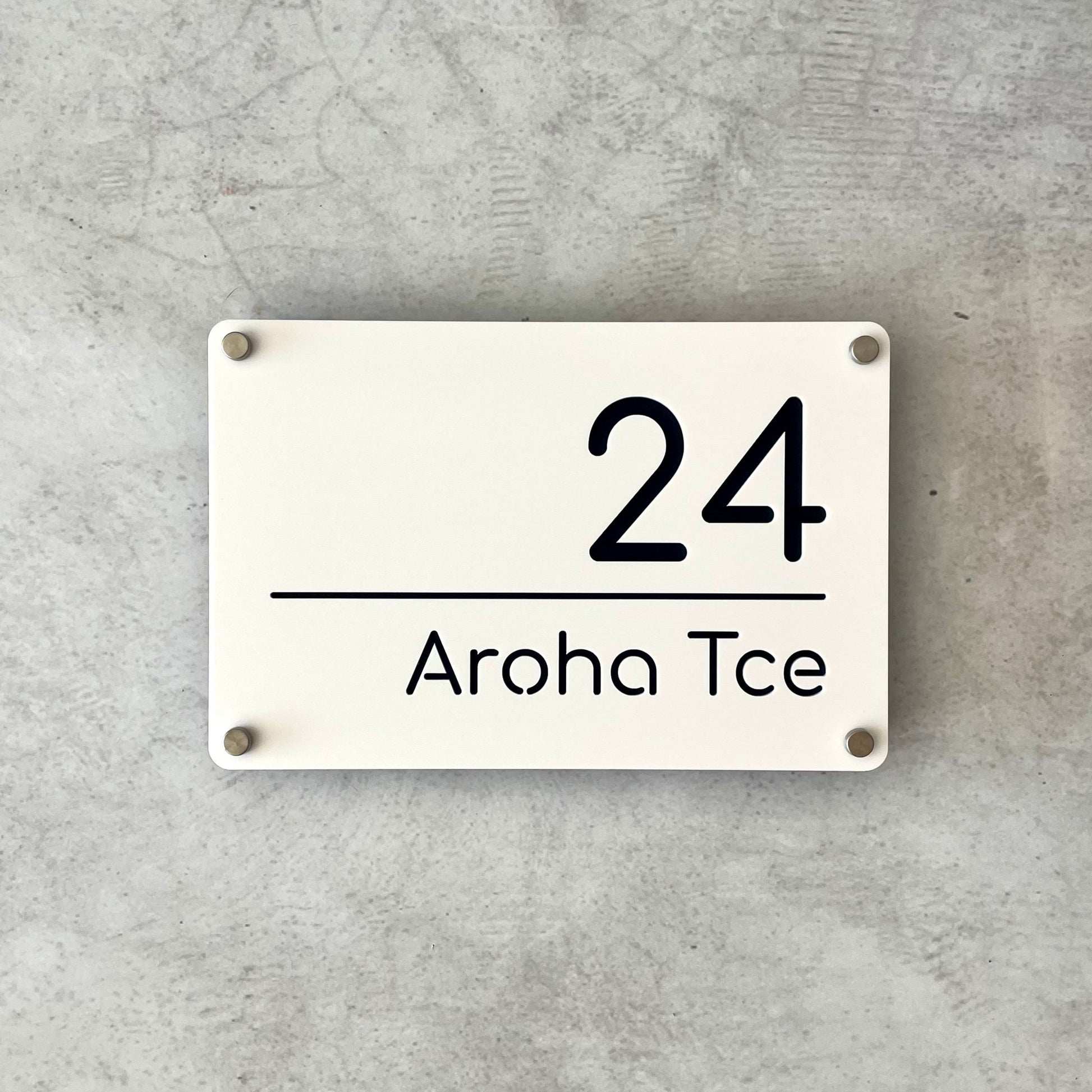 White acrylic rectangular sign with black featuring standoff screws