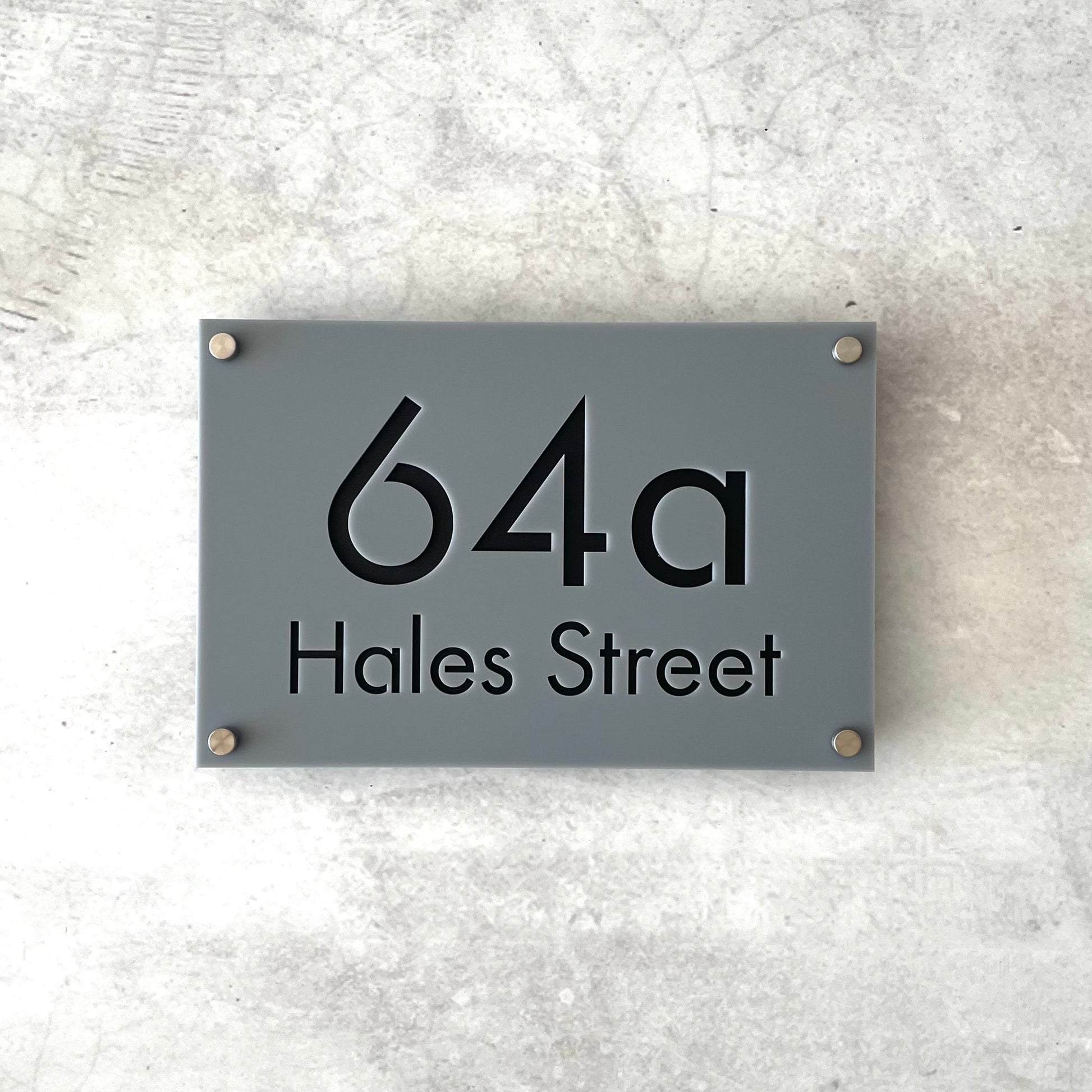 Gray house number sign, fixed with floating mounts