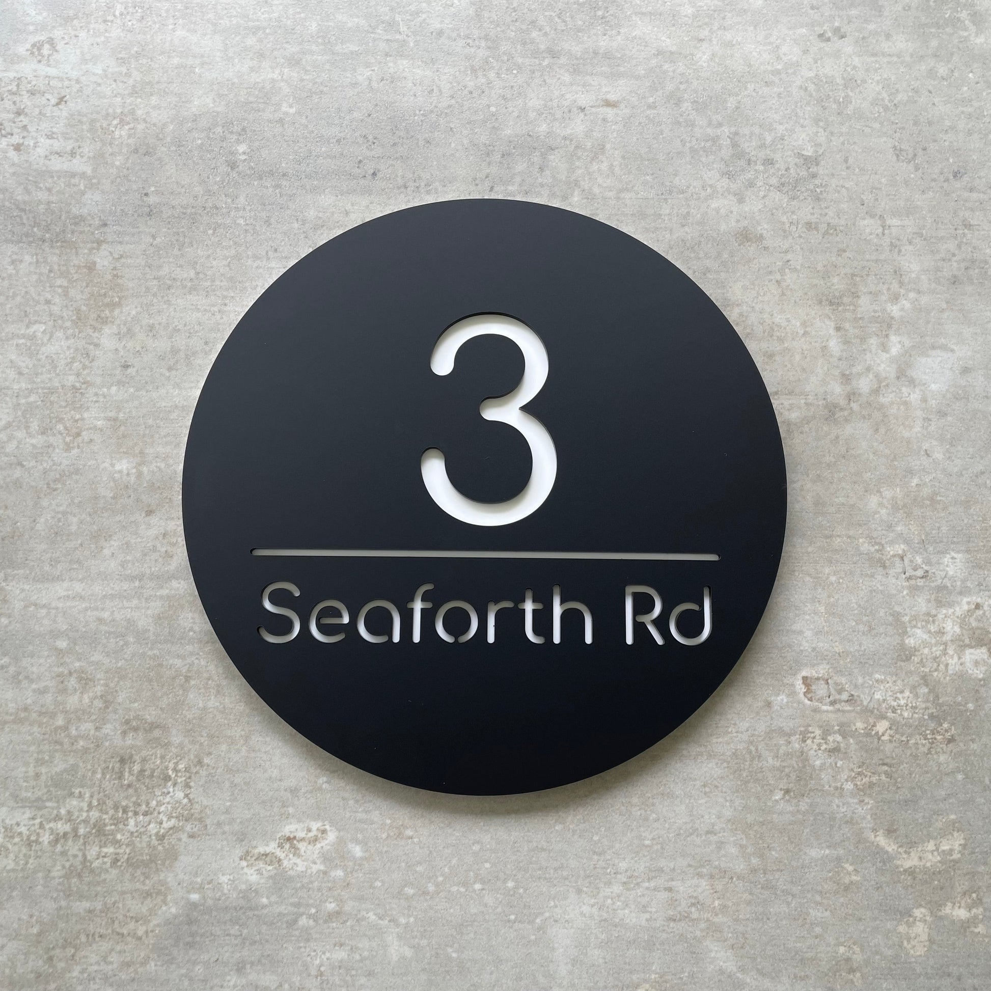 Modern circular house number with number and street