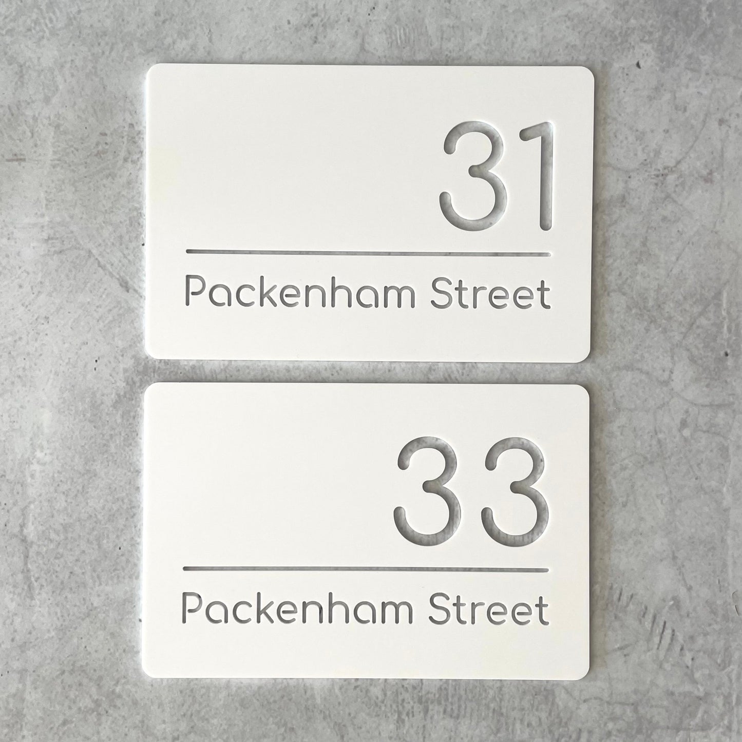 Pair of matching single layer white rectangular house number plaque with modern font. Ideal for townhouses.