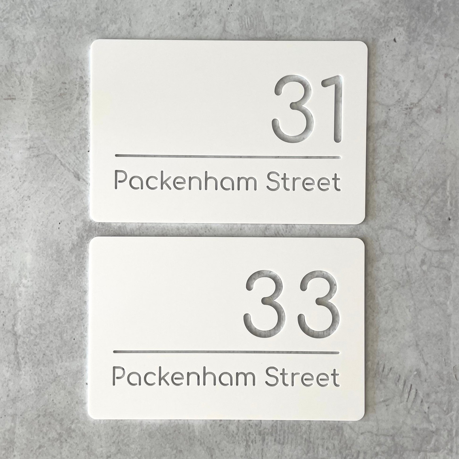 Pair of matching single layer white rectangular house number plaque with modern font. Ideal for townhouses.