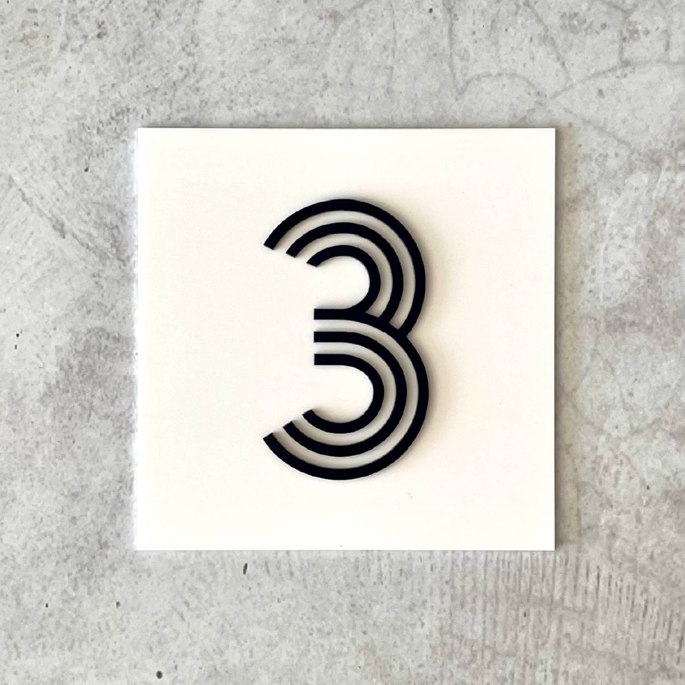 personalised house number with 3D raised acrylic letters in white and black acrylic