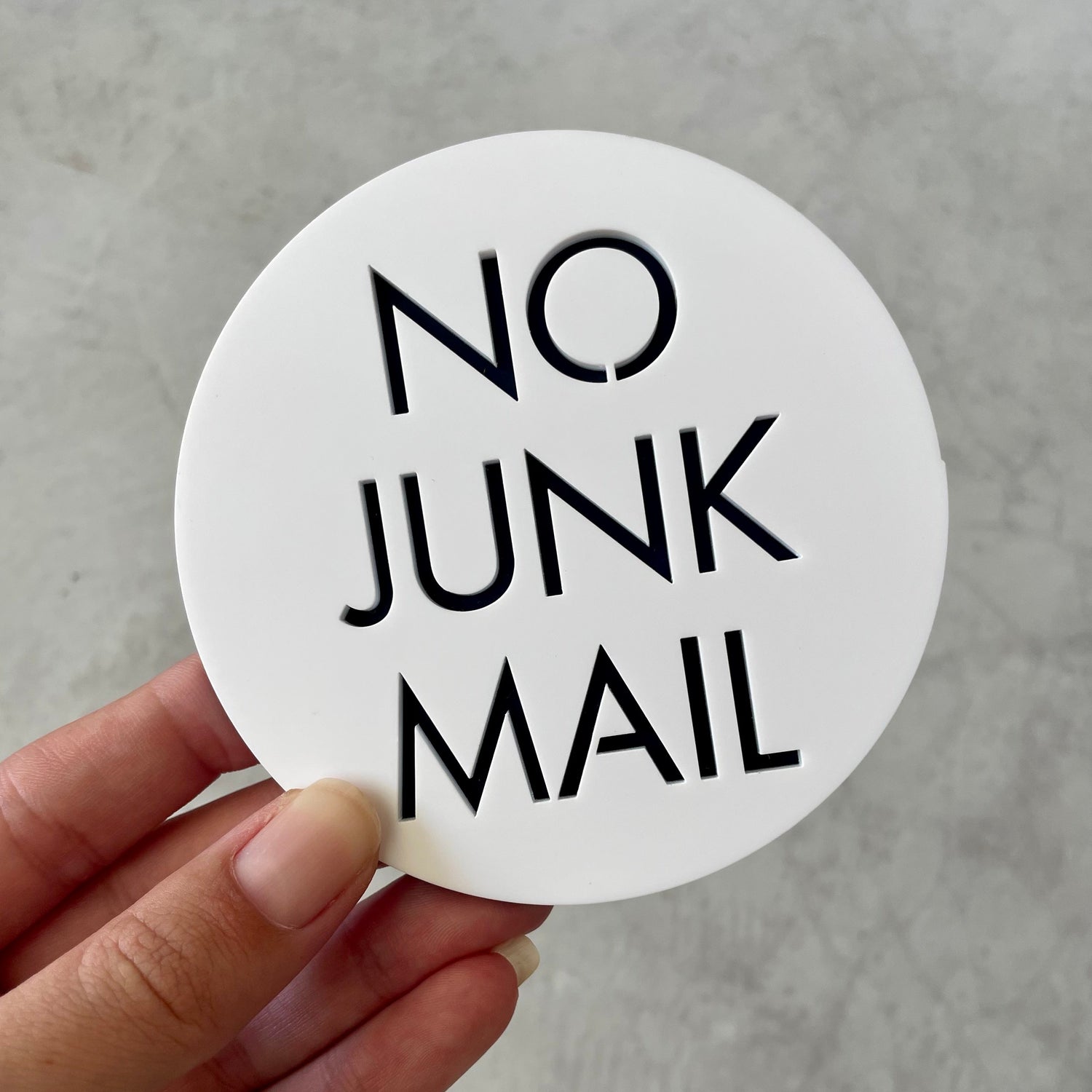 Modern round no junk mail sign, white acrylic with black text