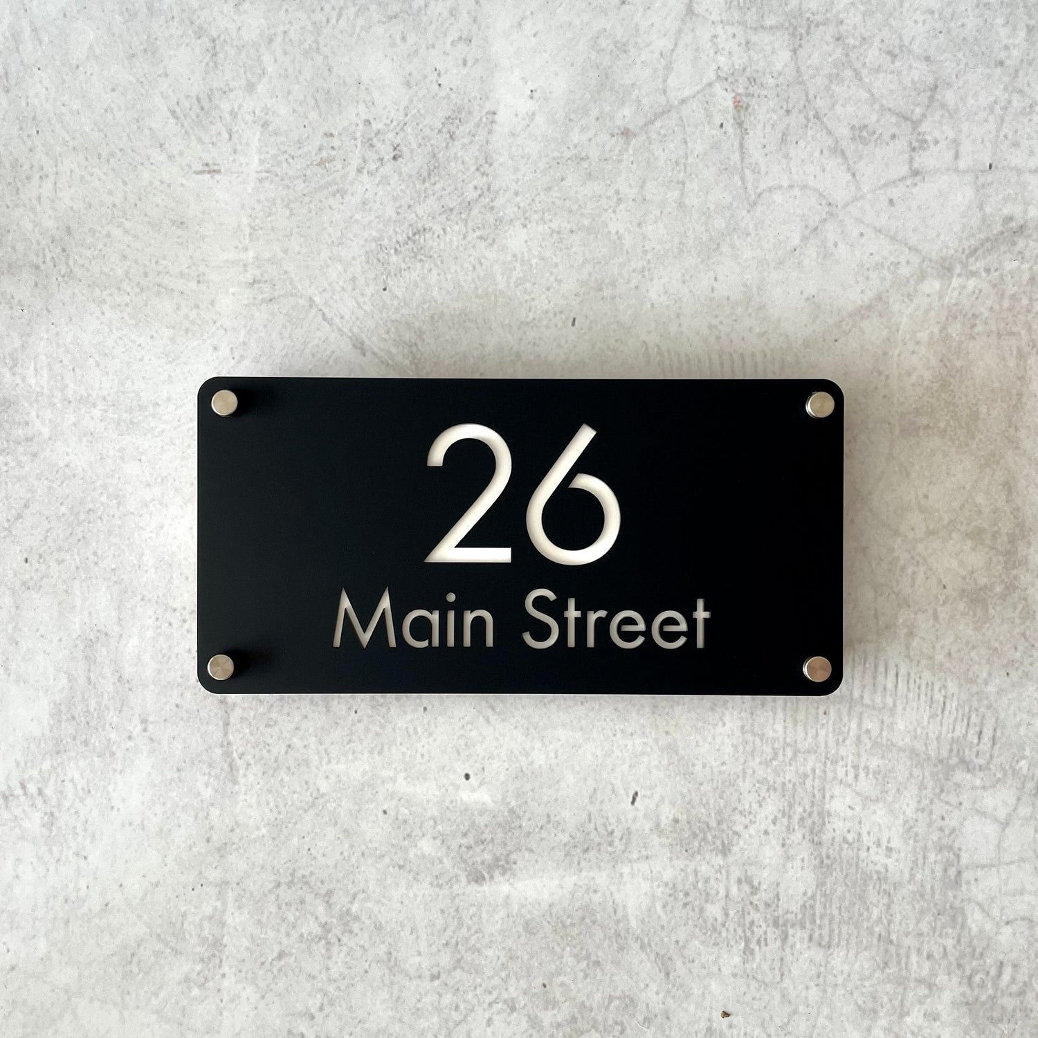 Double-layer black acrylic address plaque showing house number and street name