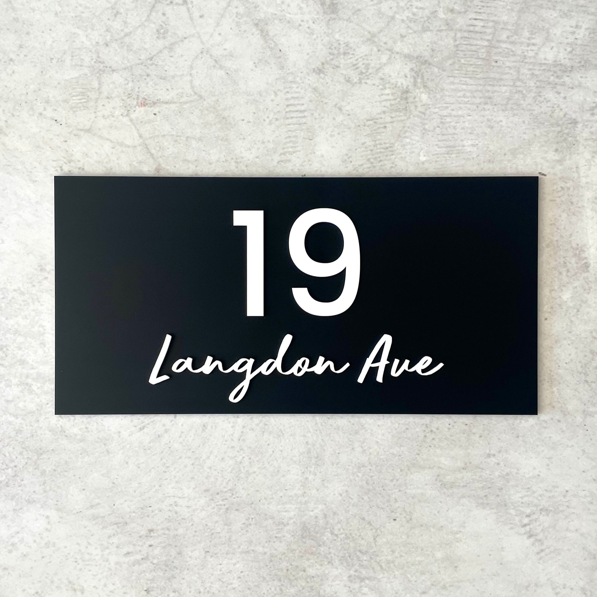 Unique house number featuring street name in a modern script font