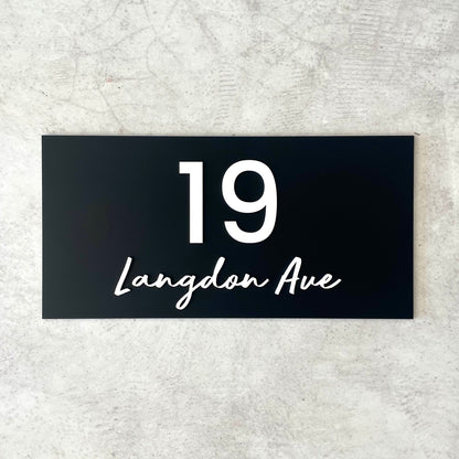 Unique house number featuring street name in a modern script font