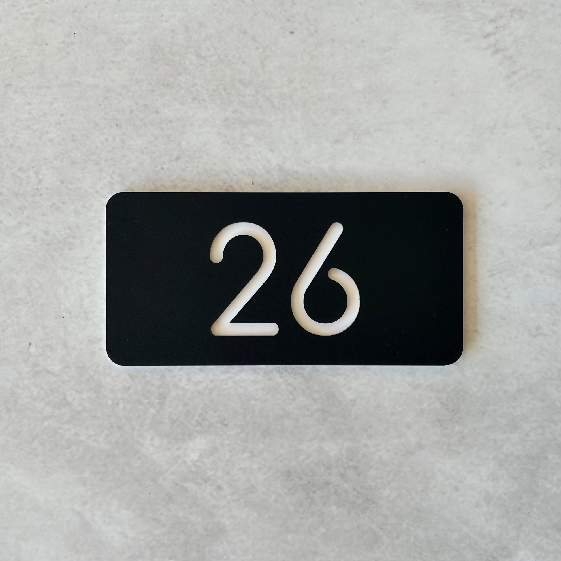 minimalistic unit number in black with white font