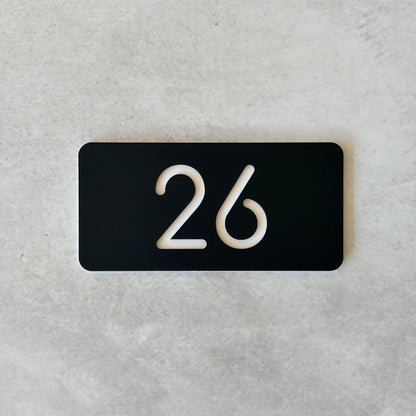 minimalistic unit number in black with white font