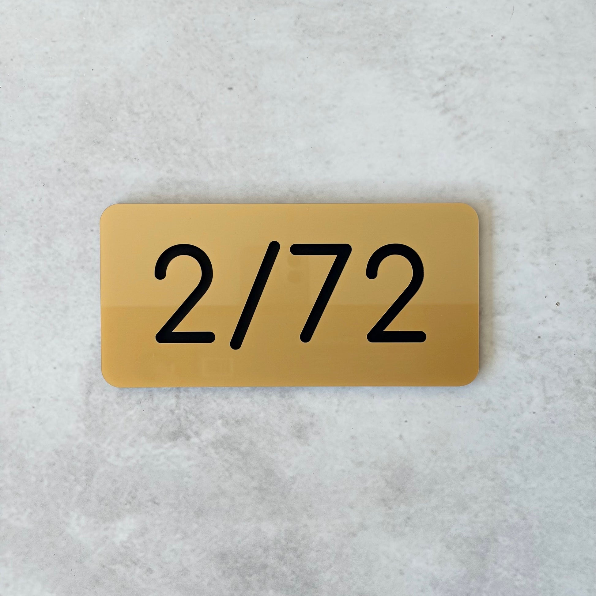 gold unit number with black lettering