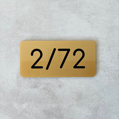 gold unit number with black lettering