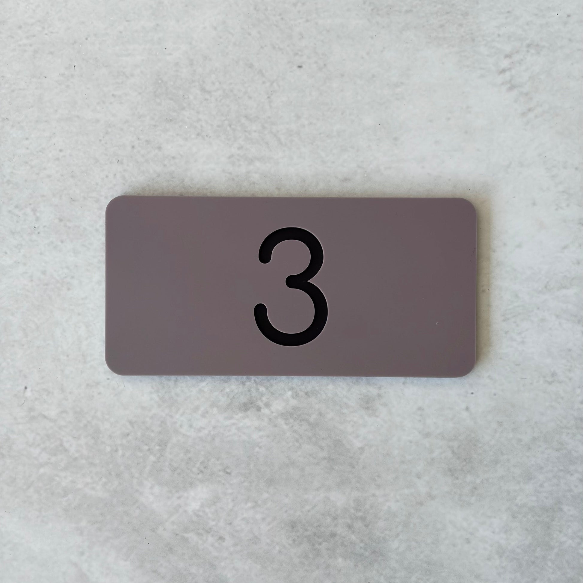grey apartment numbers with black lettering