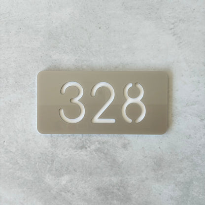 silver unit number with white backing