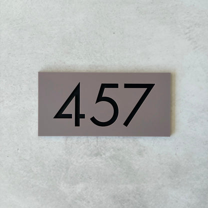 grey acrylic unit number sign with black text