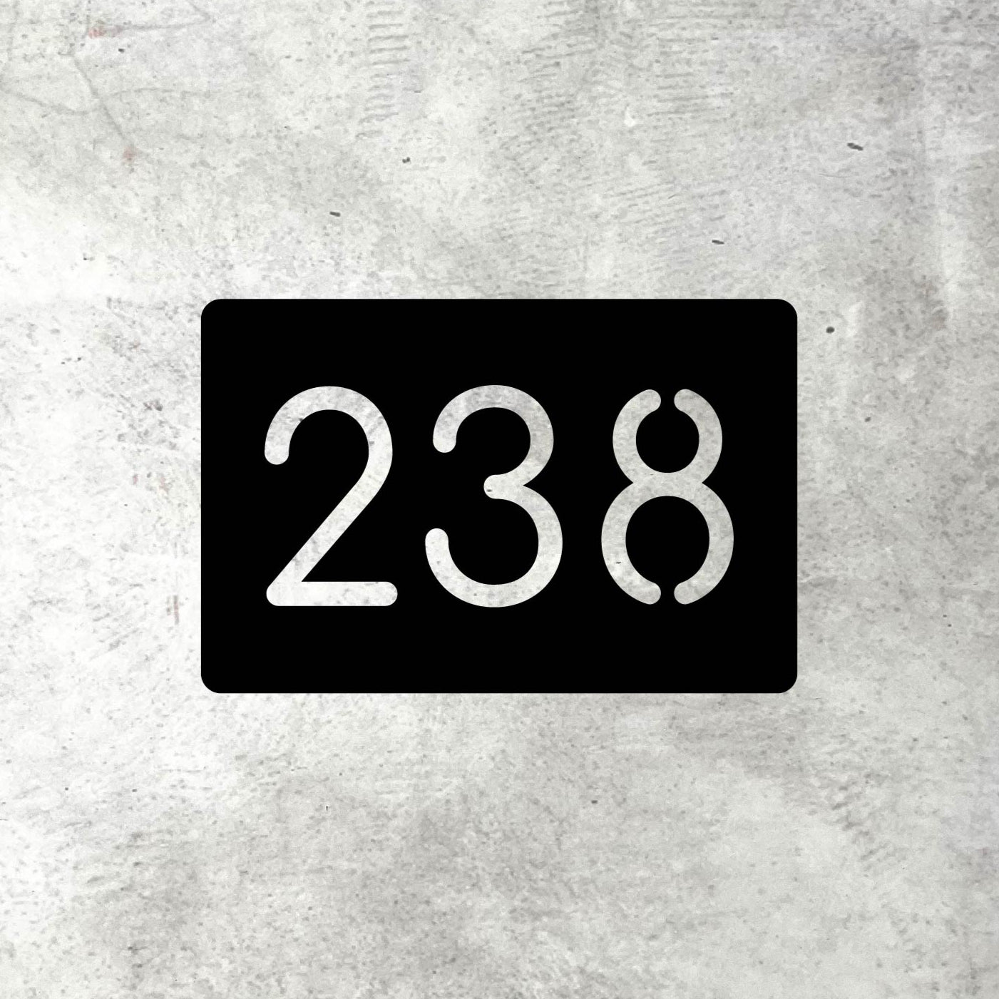 Black rectangular house number sign to create modern curb appeal