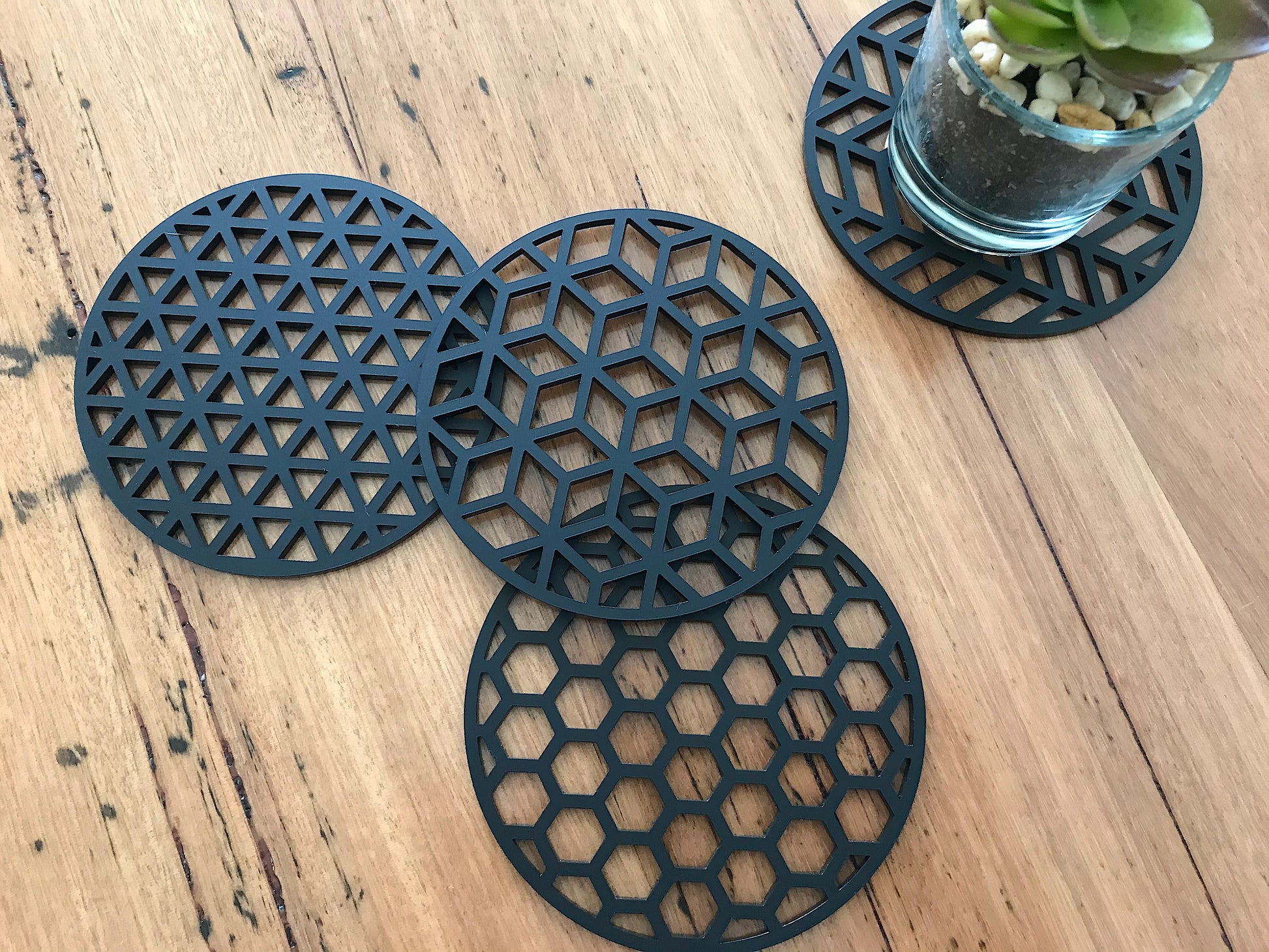 set of 4 modern geometric coasters made of black acrylic